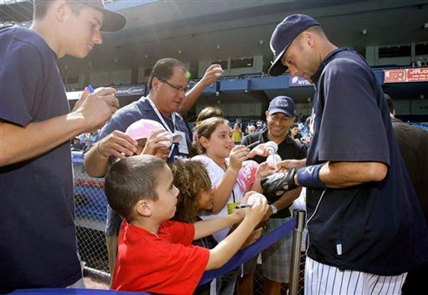 Derek Jeter signs autographs before today's game.